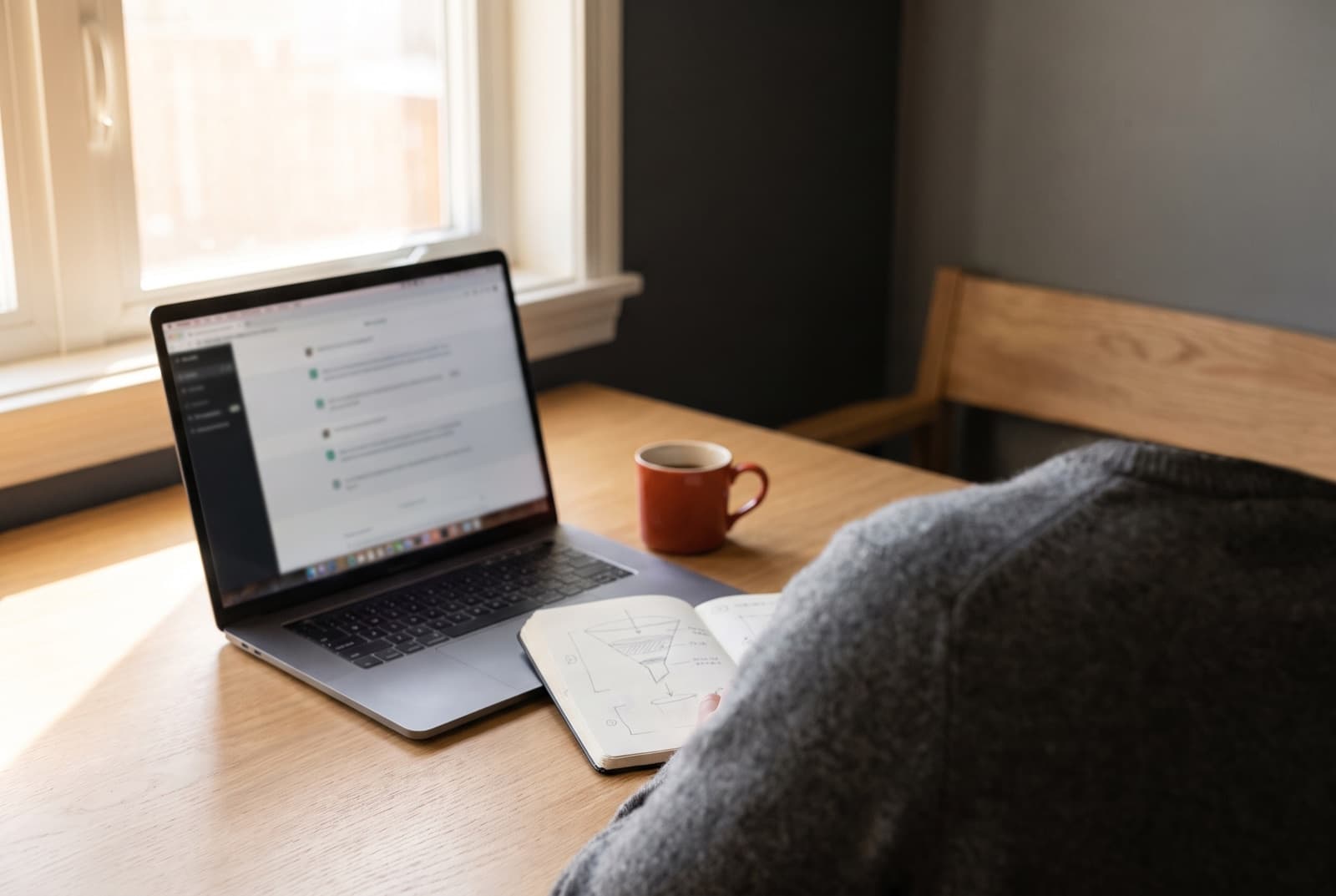 A business owner at a desk working through an interview on a laptop